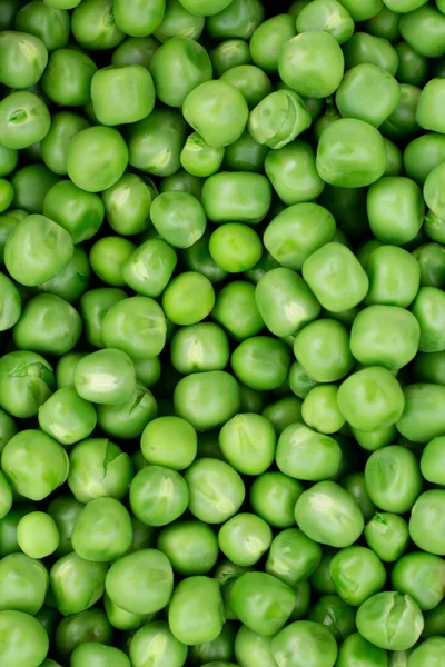 Green peas. Green background. Pea background. View from above. Green pea background. Pea pods from farmland. Pea freshly picked. Organic fresh vegetables. Healthy eating. Country garden harvest.