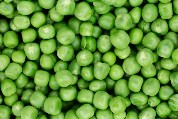 Green peas. Green background. Pea background. View from above. Green pea background. Pea pods from farmland. Pea freshly picked. Organic fresh vegetables. Healthy eating. Country garden harvest.