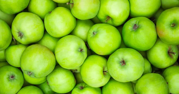 Green apples background. Lots of homemade natural apples. Healthy organic fresh food. Proper nutrition and vitamins. High quality photo