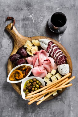İtalyan aperatifi ve kırmızı şarap: prosciutto, salam, güneşte kurutulmuş domates, zeytin, peynir, Grissini ve hurma. Yaz atıştırması