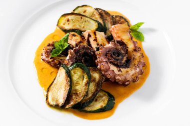 cooked octopus, served with courgettes and sauce