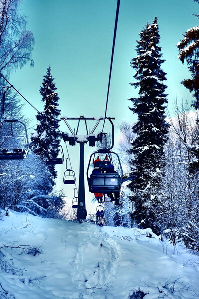 Snow-covered trees in hoarfrost at a ski resort, lift, funicular, ski lift