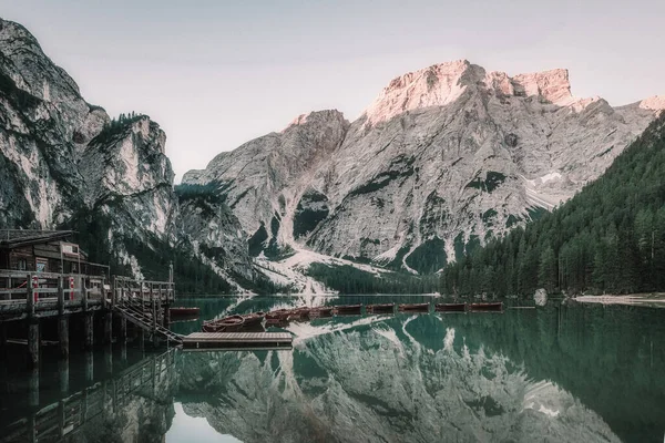 landscape of a lake with boats surrounded by mountains