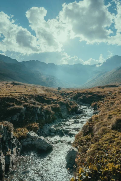 Sunny scenery of a river flowing through the mountains