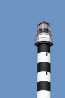 Black and white striped lighthouse on a blue background