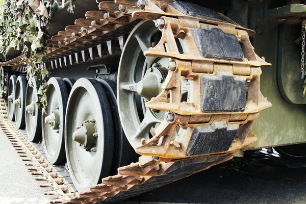 Kamuflaj ağlı askeri tankın ön manzara izleri ve tekerlekleri.