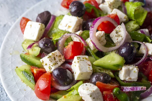 Greek salad with fresh vegetables, feta cheese and kalamata olives. Healthy food.