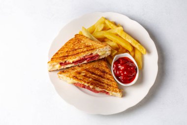 Türk tostu, çedar peyniri, sosis ve jambonla karıştırılmış tost, kızarmış patates (Türk adı Karisik tost))