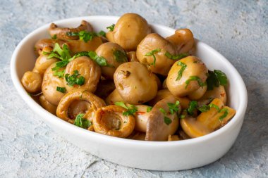 marinated mushrooms with parsley in a bowl