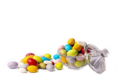 Colorful almond candies in the stylish,crystal candy bowl on white with copy space.The Sugar Feast concept. (Turkish name; Ramadan - Ramazan bayrami, Seker bayrami)