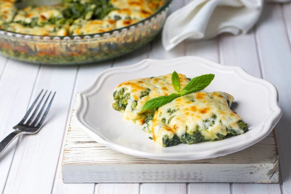 Baked Spinach with cheese delicious Italian food cuisine. Spinach gratin.