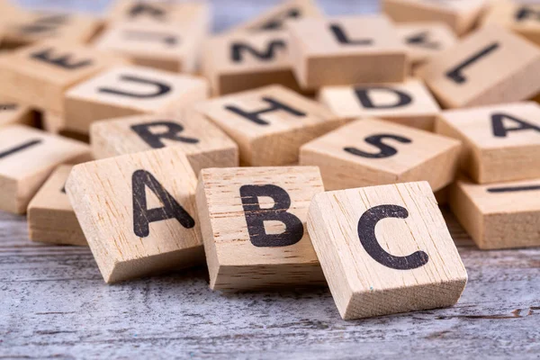Wooden alphabet on the wooden table