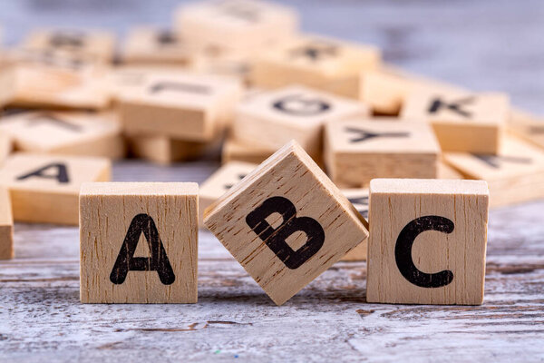 Wooden alphabet on the wooden table