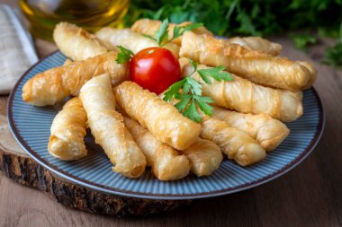 Fried pastry wrapped in cheese in phyllo. Pie in the form of a roll. Turkish name; Kalem borek - sigara boregi
