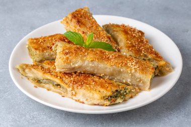 Yunan mutfağı; fırında ıspanaklı ıspanak peynirli turta üzerine spanakopita susamı. Türkçe adı: ispanakli borek