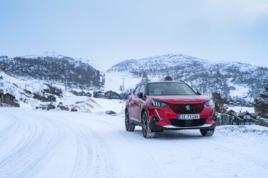 Rauland, Norveç - 14 Ocak 2022: Kırmızı elektrikli otomobil Peugeot e-2008 GT yeni bir SUV elektrikli otomobil.. 