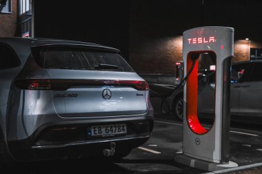 Sandefjord, Norway - februar 25, 2022: Silver Mercedes EQC Parked At Tesla Supercharger Station. The Mercedes EQC Is A Full-sized All-electric Five-door SUV