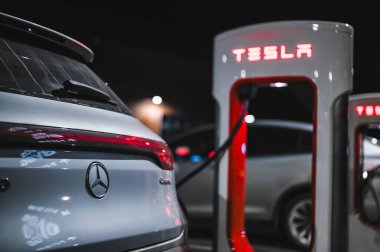 Sandefjord, Norway - februar 25, 2022: Silver Mercedes EQC Parked At Tesla Supercharger Station. The Mercedes EQC Is A Full-sized All-electric Five-door SUV