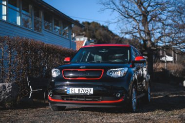 Tonsberg, Norway - April 06, 2022: black red Kia Soul is a compact C-segment electric car. New car on a sunny day close to the sea