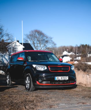 Tonsberg, Norway - April 06, 2022: black red Kia Soul is a compact C-segment electric car. New car on a sunny day close to the sea