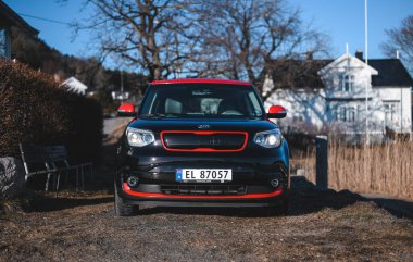 Tonsberg, Norway - April 06, 2022: black red Kia Soul is a compact C-segment electric car. New car on a sunny day close to the sea