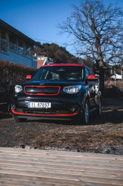 Tonsberg, Norway - April 06, 2022: black red Kia Soul is a compact C-segment electric car. New car on a sunny day close to the sea
