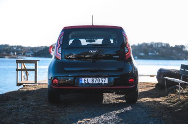 Tonsberg, Norway - April 06, 2022: black red Kia Soul is a compact C-segment electric car. New car on a sunny day close to the sea