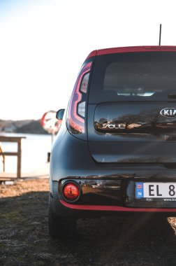 Tonsberg, Norway - April 06, 2022: black red Kia Soul is a compact C-segment electric car. New car on a sunny day close to the sea