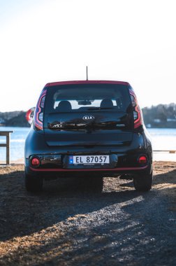 Tonsberg, Norway - April 06, 2022: black red Kia Soul is a compact C-segment electric car. New car on a sunny day close to the sea