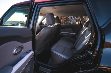 Tonsberg, Norway - April 06, 2022: black red Kia Soul is a compact C-segment electric car. New car on a sunny day close to the sea