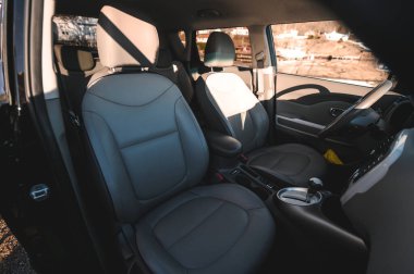 Tonsberg, Norway - April 06, 2022: black red Kia Soul is a compact C-segment electric car. New car on a sunny day close to the sea