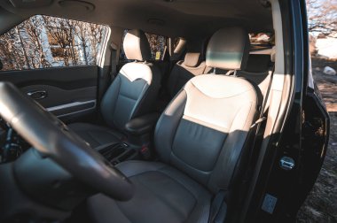 Tonsberg, Norway - April 06, 2022: black red Kia Soul is a compact C-segment electric car. New car on a sunny day close to the sea