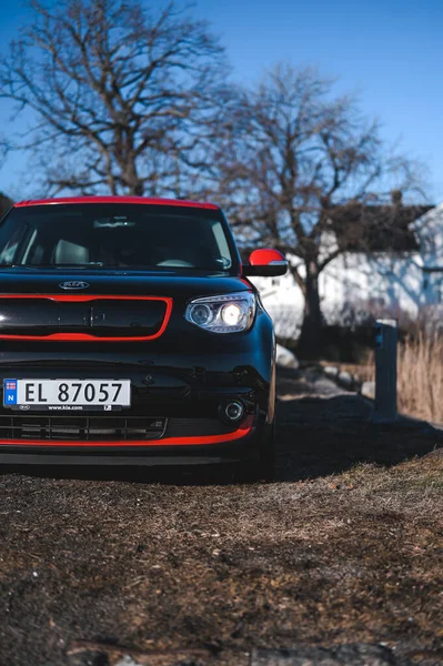 Tonsberg, Norway - April 06, 2022: black red Kia Soul is a compact C-segment electric car. New car on a sunny day close to the sea