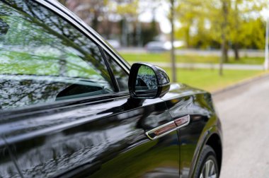 Notteroy, Norway - may 27, 2022: black electric SUV Hongqi around green foilage 