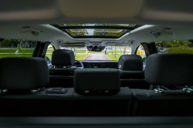 Notteroy, Norway - may 27, 2022: black electric SUV Hongqi around green foilage 