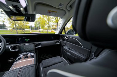 Notteroy, Norway - may 27, 2022: black electric SUV Hongqi around green foilage 