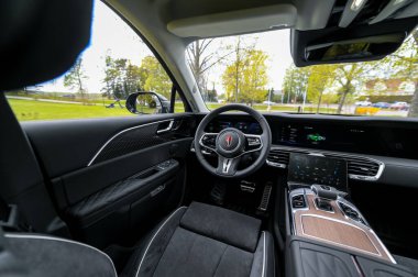 Notteroy, Norway - may 27, 2022: black electric SUV Hongqi around green foilage 