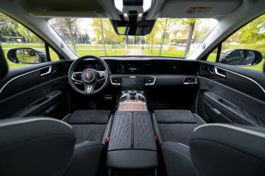 Notteroy, Norway - may 27, 2022: black electric SUV Hongqi around green foilage 