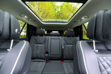 Notteroy, Norway - may 27, 2022: black electric SUV Hongqi around green foilage 