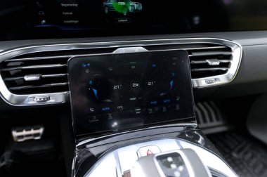 Notteroy, Norway - may 27, 2022: black electric SUV Hongqi around green foilage 