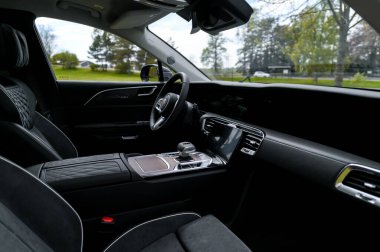 Notteroy, Norway - may 27, 2022: black electric SUV Hongqi around green foilage 