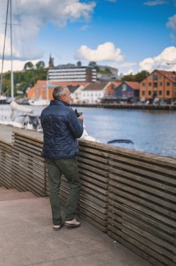 attractive old man walking in the city  lifestyle portrait with Tonsberg viewpoint