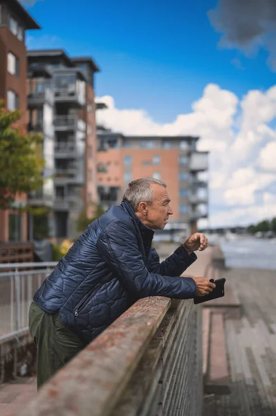 attractive old man walking in the city  lifestyle portrait with Tonsberg viewpoint