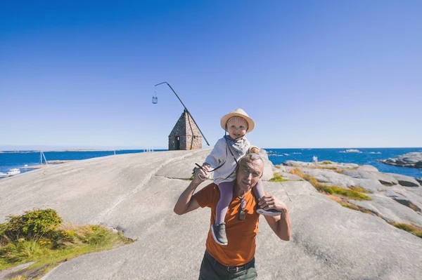 Noway, Verdens Ende Tjome summer view point tourist place in Vestfold. Grandpa with grandkid cute boy. happy childhood