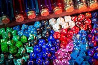Close-up image of colorful role-playing gaming dice and potions in glass bottles clipart