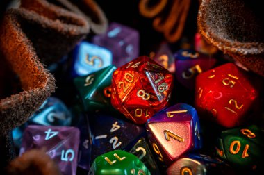 Close-up image of various colored role-playing gaming dice in a dice bag clipart