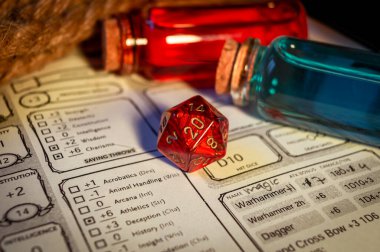 Close-up image of a red 20-sided role-playing gaming die on a character sheet. Within the background magic potions clipart