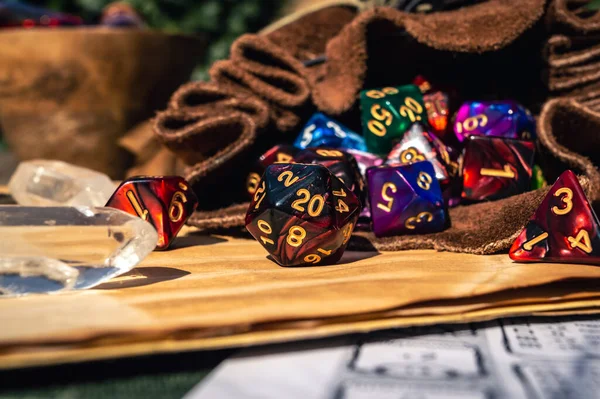 Close-up image of colorful role-playing dice spilling out of a leather dice bag