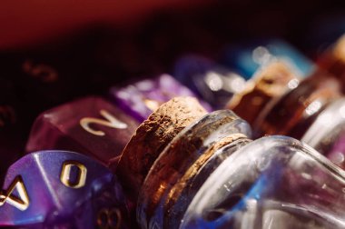 Close-up image of a glass potion bottle with a cork stopper and RPG dice
