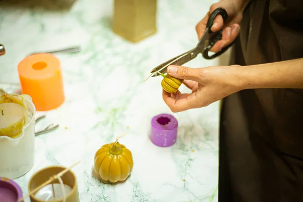 the process of making a pumpkin candle for Halloween, the concept of preparing for Halloween on Memorial Day.